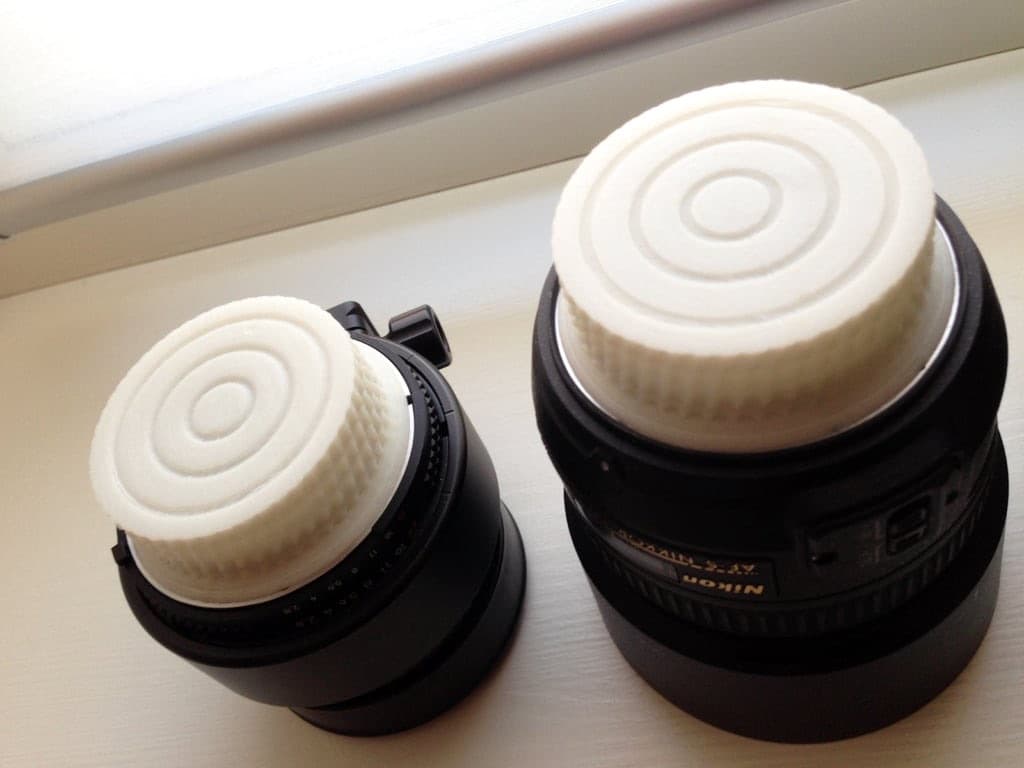 Nikon F-mount rear lens caps fitted on two lenses